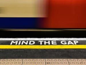 a picture of the London underground with "Mind the gap" on the floor.