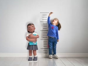 A picture of a child stood next to a Social Care & Education System C child character.