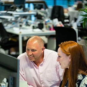 staff in front of a computer