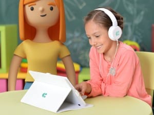 A child on a System C iPad sat next to a System C education character.