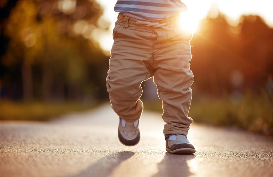 Child walking in the sunset