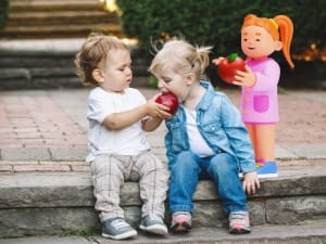 2 children sat eating an apple with a System C Social Care & Education child character.